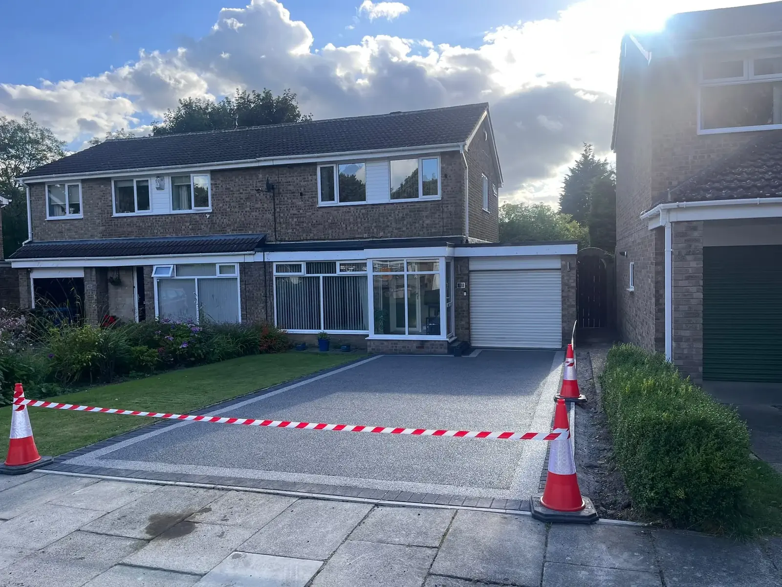 Completed silver grey resin bound driveway with block paved border at a semi-detached Newcastle home